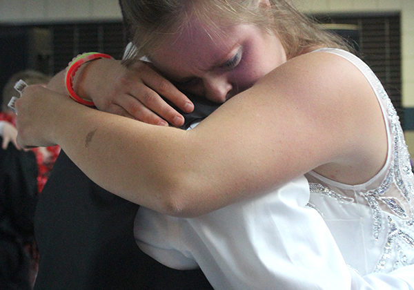 Taylor Roeda (12) cries on Alec Bisone’s (12) shoulder during a slow song. The night featured a mix of different music genres.