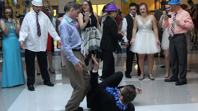 Students gather in a dance circle around Austin Huber (12) and Nick Rossi (12). Best buddies held this dance every year.