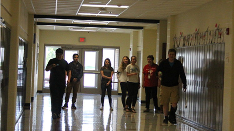 The French club members gather in the hallway outside of Beverly Bovard’s, World Language, classroom. They began the relay race two at a time.