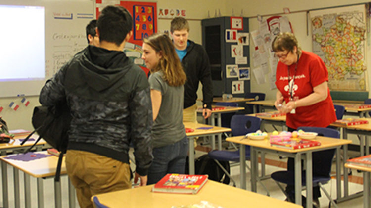 Beverly Bovard, World Language, explains the directions of the game to the club members. They each grabbed a plastic Easter egg and headed out into the hallway.