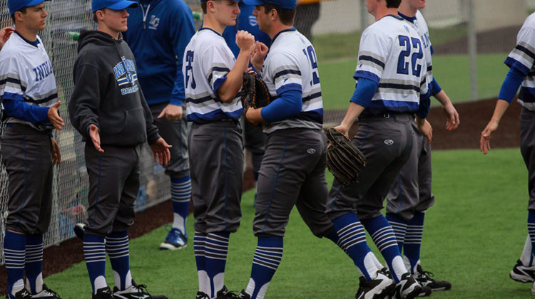 Christopher Fundich (12) bumps fists with the other players. The boys next game is May 16 at home.