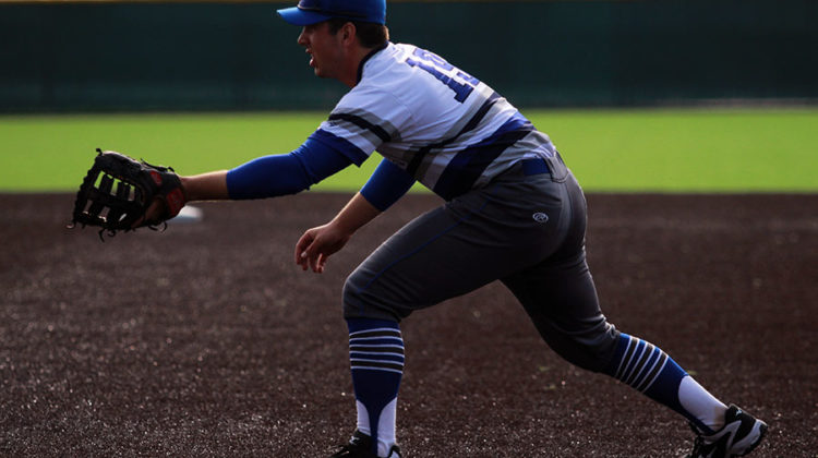 Christopher Fundich (12) gets in position after Graziano pitches the ball. He was number 19 on the team.