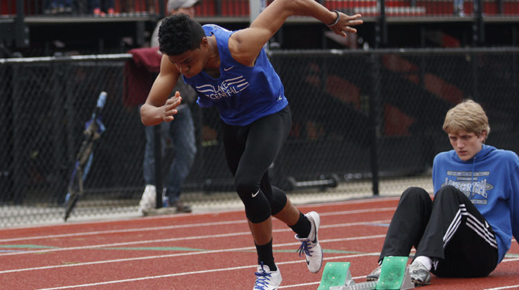 Joshua Benson (12) blasts off the start block. Benson competed in the 400-meter dash.