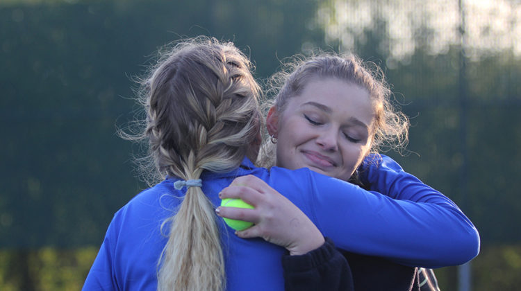 The varsity girls tennis team won at their last home match of the season. Claire Gronek (11) hugged Sky Martens (12) after her and her doubles’ partner, Anna Wachowski (12), clinched the win against Valparaiso.