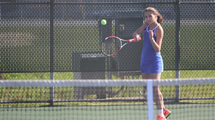 Danica Mileusnic (10) swings at the ball to try to beat her opponent. Mileusnic ended up losing with a score of 1 to 2.
