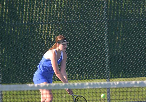 Colette Oboy (11) retrieves the ball and hits it back to her opponent. Oboy won her game with scores of 7-5 and 6-1.