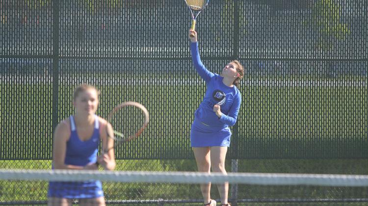 Anna Wachowski (12) serves the ball during her doubles match against Valparaiso. Wachowski and her partner, Claire Gronek (11), won two out of three sets.