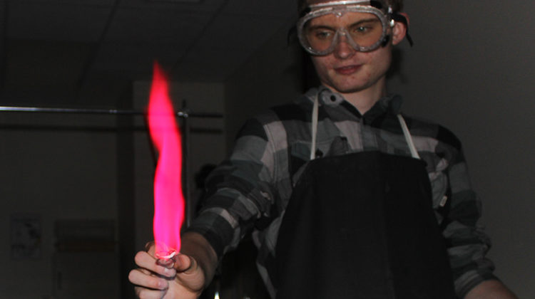 Joseph Kane (11) puts the chemical copper into the flame. Kane was in the ACP 2 Chemistry class.
