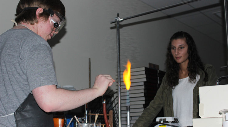 Hatfield and Gina Symborski (11) watch the flame. Symborski lead the callout meeting.