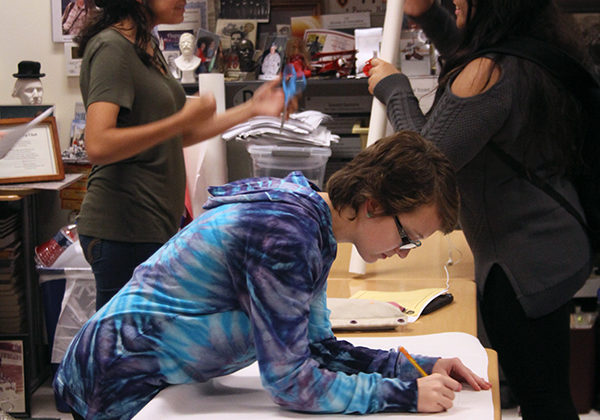 Maya McCants (12) works on making a poster for the food drive. Students were able to stay after to help, but were not required to.