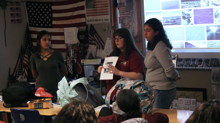 The Interact Club leaders speak to members about the food drive. Students had the opportunity to earn service hours by helping make posters as the meeting came to an end.