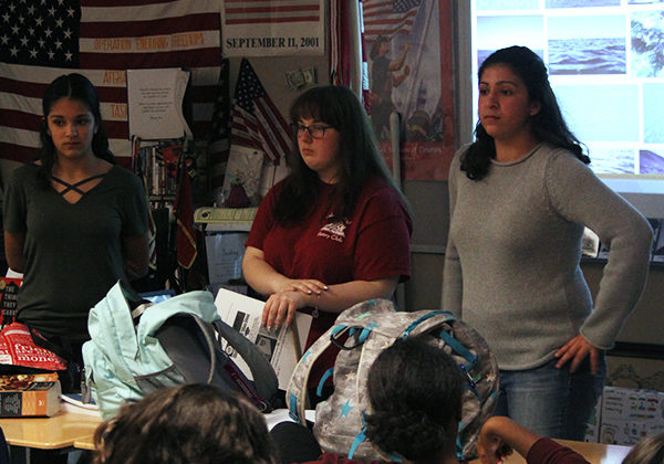 The leaders stand at the front of the classroom and discuss upcoming events that they are in charge of. They discussed the Veteran’s Day assembly and a Halloween party.