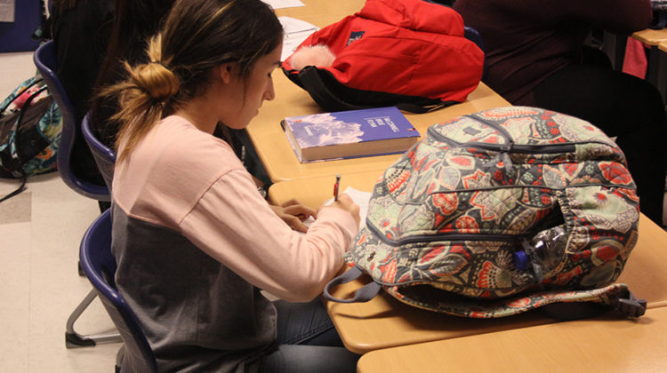 Katerina Petreska (12) signs in during the meeting. The next Interact Club meeting will be held on Oct. 17.