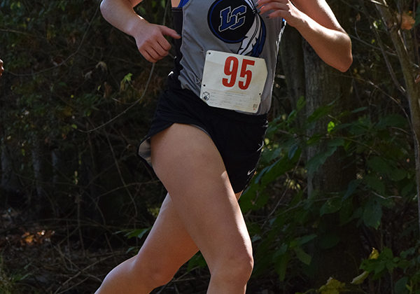 Lilly Zubeck (10) begins her third lap, Zubeck is a sophomore who runs on Varsity.