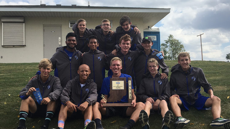 The boys cross country postseason team poses with their Sectionals trophy. The next race is Saturday, Oct. 14.