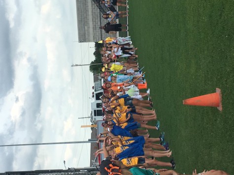 Girls participating in the parade start the wave while waiting for awards to be presented. Awards were given out to teams that won the skills competition. 