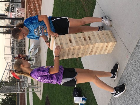 Two girls play Jenga together during the block party. The block party was held from 6:30-10 p.m. 