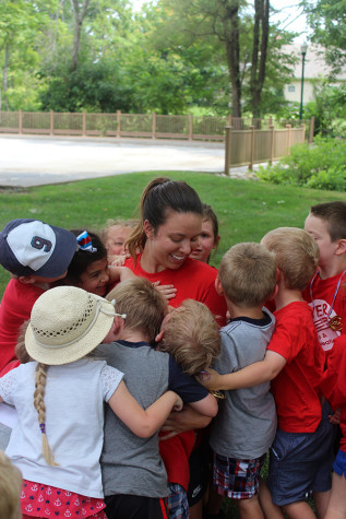 The kids gather around to give one last hug to Erin Kramer, camp director, on their last day of camp. Kramer has directed both camps for the last five years.