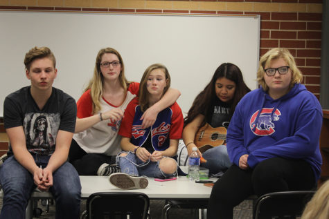 A group of students sit and wait for the next person or group to perform. Most things performed at this meeting were songs, jokes and stories. 